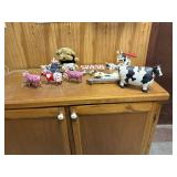 Assortment of cows and stuffed dog