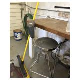 Craftsman stool and yellow push broom.