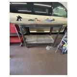 Work bench and items on top includes level,