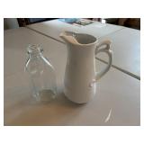White pitcher and  milk bottle