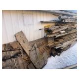 Large lot of Lumber and Sheeting on Back Wall of
