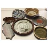 Seven Handmade Pottery Pieces Featuring Various Tr