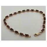 10K Gold Garnet Tennis Bracelet 7 ins.