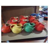 10 Small Ceramic Pitchers in Orange, Green, and Ye