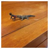Small Metal Sculpture of Crocodile Biting Human Fi