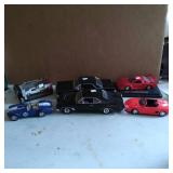 Six Die-Cast Model Cars in Various Scales