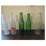 Vintage Soda Bottles Including Pepsi-Cola and Spri