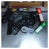 Three Wii Remotes with Sleeves and Super Nintendo