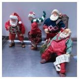 Four Santa and Holiday Figurines with Various Atti