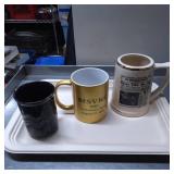 Three Ceramic Mugs with Varied Designs and Themes