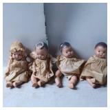 Four Composition Dolls with Cloth Dresses