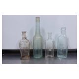 Four Embossed Glass Bottles, Various Makers