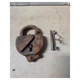 Rusty Iron Padlock with Key and Integrated Locking