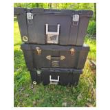 Three Locked Black Plastic Storage Containers