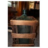 Antique water jug with crate
