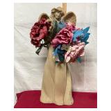 decorative angel figurine holdin flowers