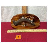 Handmade wooden train on bent Railroad Spike