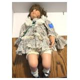 Porcelain 24" Doll that is in a Sitting Position