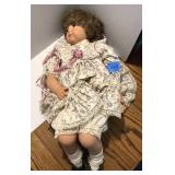 Porcelain 24" Doll that is in a Sitting Position