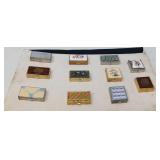 COLLECTION OF 11 VINTAGE PILL BOXES GLUED TO FELT