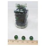 JAR OF DARK GREEN MARBLES APROX 3/4'