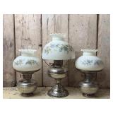 Three Polished Metal Oil Lamps with Floral Shades
