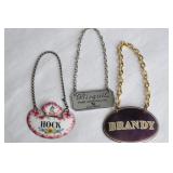 3 Various Decanter Labels/Tags. Two enameled.