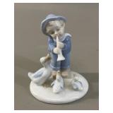 Porcelain figurine, a young boy in blue overalls