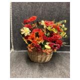 Artificial flowers in wicker basket