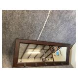 Wall mirror with hooks