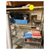 Shelving unit with contents of nails, bits,