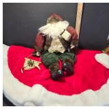 Decorative Santa Figurine and Red Tree Skirt