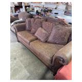 Large brown living room, couch with pillow pillows