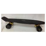 Black Plastic Skateboard with Gold Trucks and Blac
