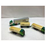 Four Die-Cast Model Trucks With Trailers