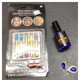 Pastel Makeup Sticks, Nail Polish, and Blue Pendan