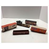 Five Model Railroad Train Cars Featuring Advertisi