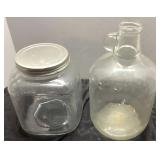 Two Clear Glass Containers, One With Handle and On