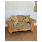 Tan Upholstered Loveseat with Wood Trim and Throw Pillows