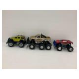 Three Radio Controlled Monster Trucks... no controllers