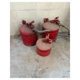 Three Red Metal Gas Cans