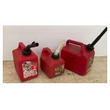 Three Red Plastic Gasoline Cans