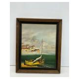Framed Artwork of Coastal Town with Boat