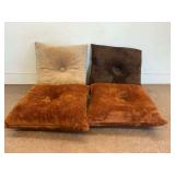 Four Decorative Plush Pillows in Tan, Brown, and Rust