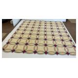 Patterned Quilt with Gray Circles and Blue and Red Diamonds