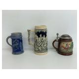 Two Beer Mugs and Stein with Figures and Landscape Details