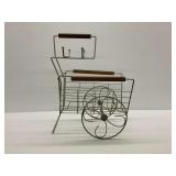 Mid Century Metal Magazine Rack with Wooden Accents and Decorative Spoked Wheels