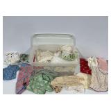 Textile Lot with Vintage Aprons in Plastic Storage Bin