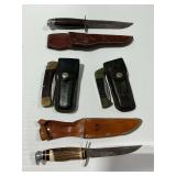 (4) Hunting Knives with Leather Sheaths by Buck, Case, Western, and Sword and Shield