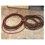 Two Coils of Red Rubber Hoses with Metal Fittings